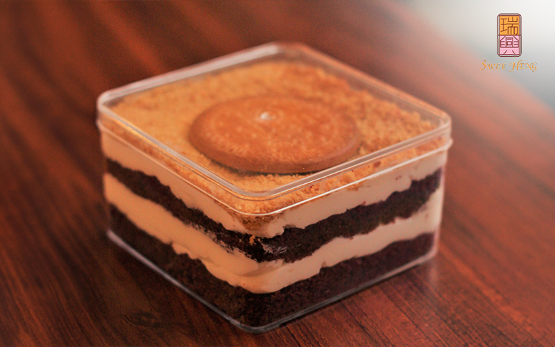 A tiramisu cake packed in a container