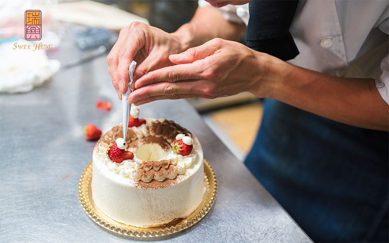 Pastry chef decorating wedding cake