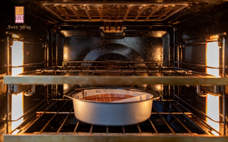 Chocolate cake batter baking in the oven