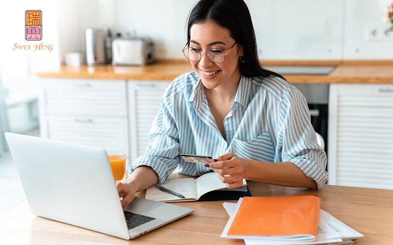 Image of Woman entering card details online to place an order