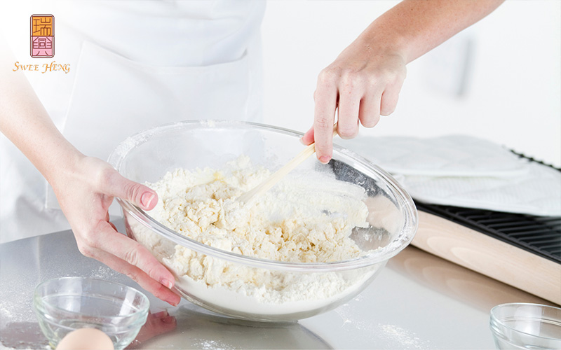 A baker mixing batter