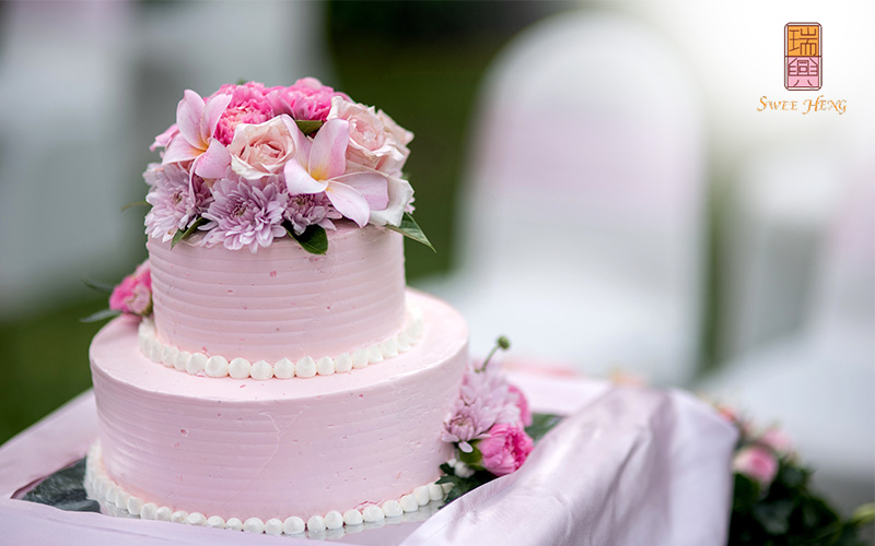 2 Tiered Pink Wedding Cake with decorative flowers