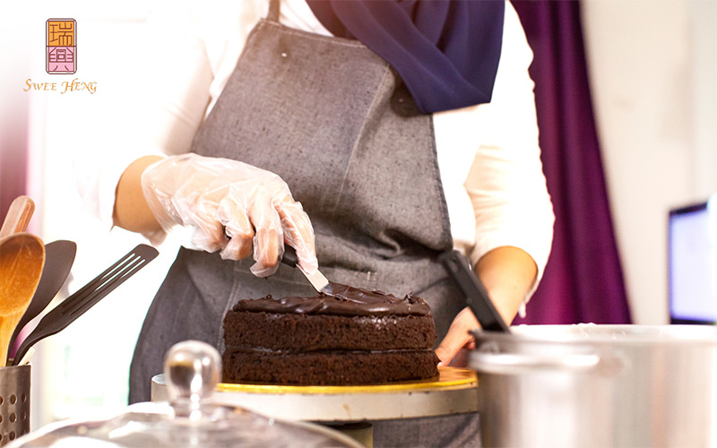 Adding Rich Layers of frosting on a cake